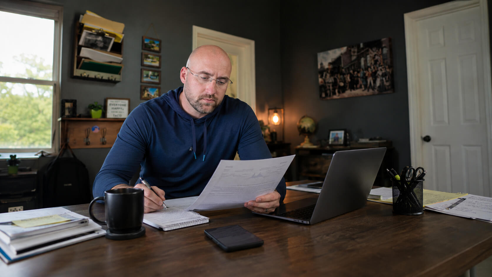 David Cote reviewing marketing reports at his desk